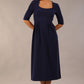 model wearing a diva catwalk Padstow Midi A-line Dress elbow length sleeves and midi length with empire waistline in navy blue colour