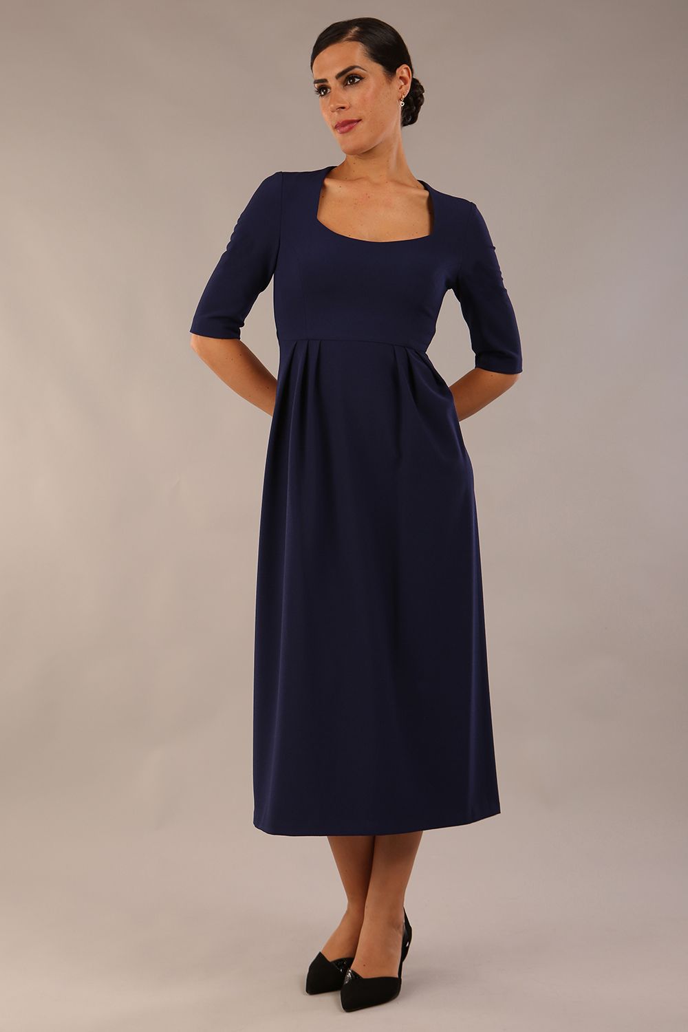 model wearing a diva catwalk Padstow Midi A-line Dress elbow length sleeves and midi length with empire waistline in navy blue colour