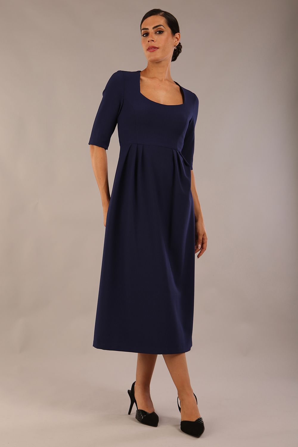 model wearing a diva catwalk Padstow Midi A-line Dress elbow length sleeves and midi length with empire waistline in navy blue colour