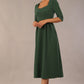 model wearing a diva catwalk Padstow Midi A-line Dress elbow length sleeves and midi length with empire waistline in hunter green colour