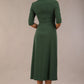 model wearing a diva catwalk Padstow Midi A-line Dress elbow length sleeves and midi length with empire waistline in hunter green colour