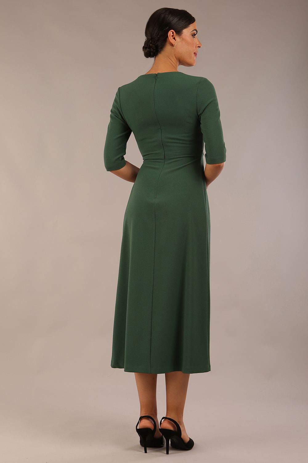 model wearing a diva catwalk Padstow Midi A-line Dress elbow length sleeves and midi length with empire waistline in hunter green colour