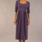 model wearing a diva catwalk Padstow Midi A-line Dress elbow length sleeves and midi length with empire waistline in dark mauve colour