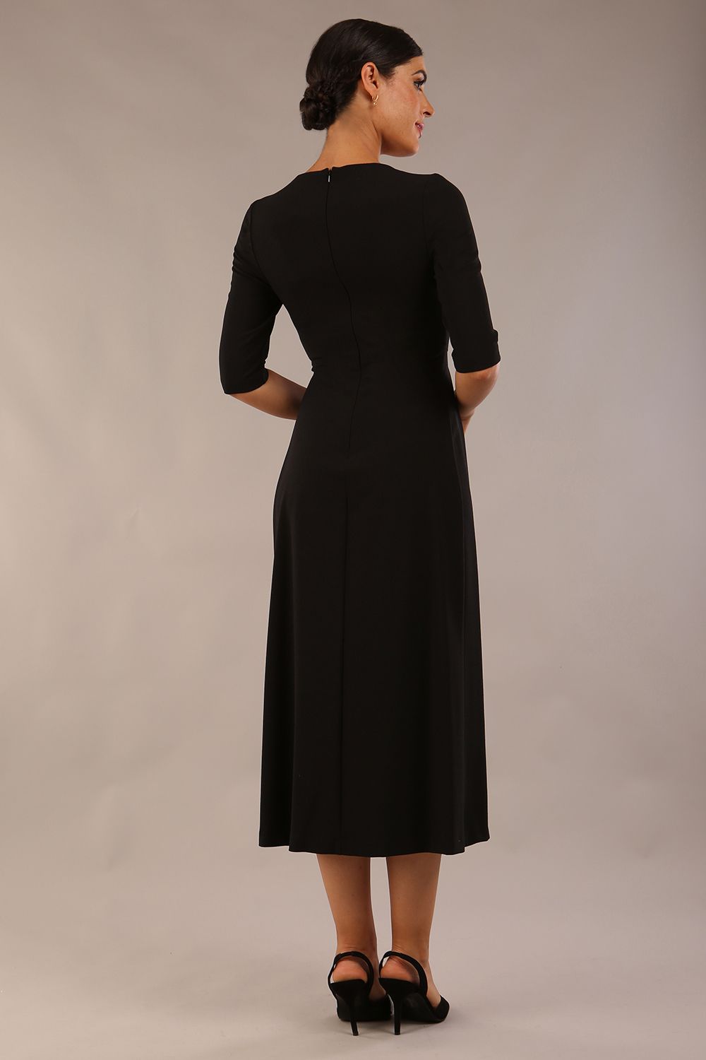 model wearing a diva catwalk Padstow Midi A-line Dress elbow length sleeves and midi length with empire waistline in black colour