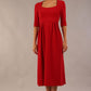 model wearing a diva catwalk Padstow Midi A-line Dress elbow length sleeves and midi length with empire waistline in passion red colour