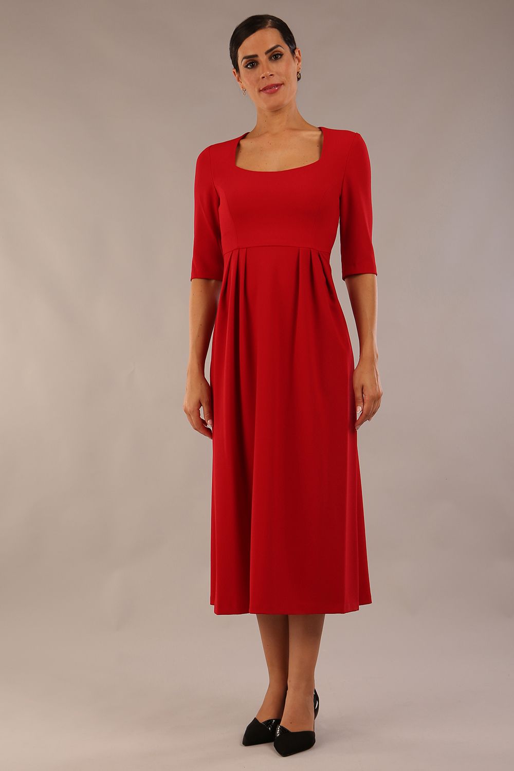 model wearing a diva catwalk Padstow Midi A-line Dress elbow length sleeves and midi length with empire waistline in passion red colour