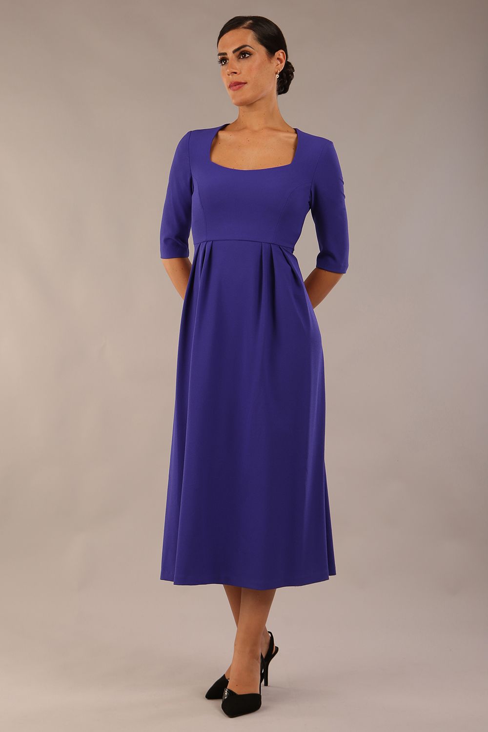 model wearing a diva catwalk Padstow Midi A-line Dress elbow length sleeves and midi length with empire waistline in spectrum indigo colour