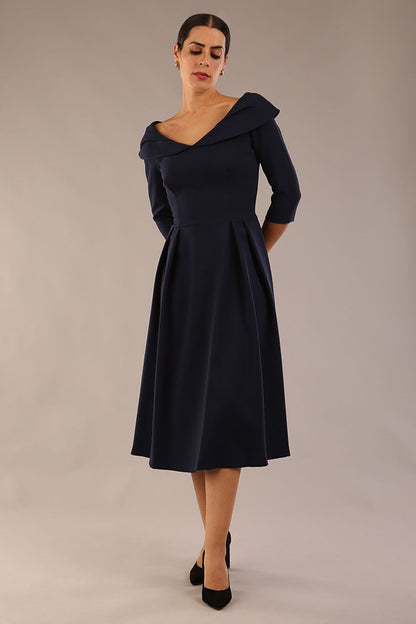 Model wearing Diva Catwalk Chesterton Sleeved dress with oversized collar detail and a-line swing pleated skirt in colour navy blue front