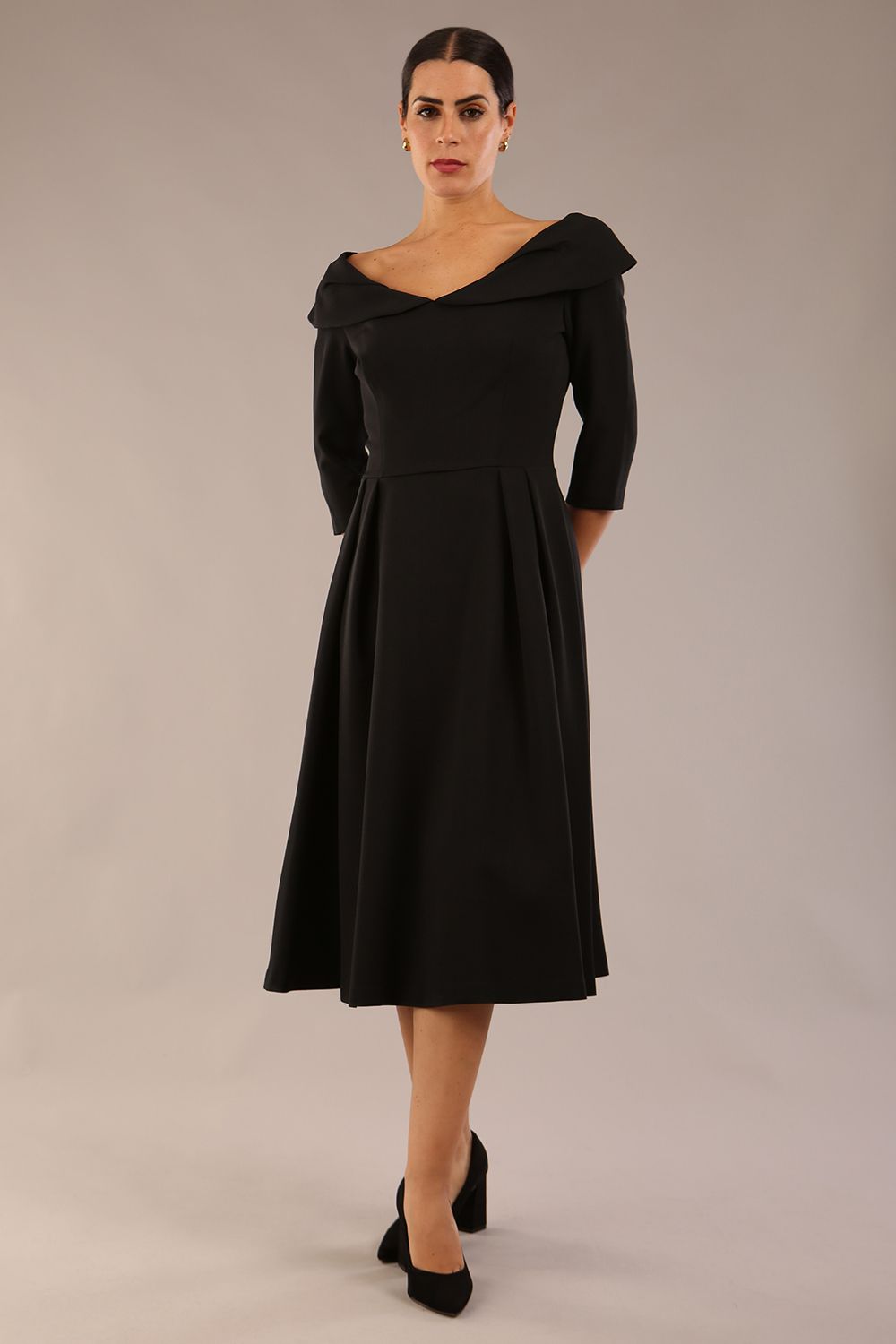 Model wearing Diva Catwalk Chesterton Sleeved dress with oversized collar detail and a-line swing pleated skirt in colour black front