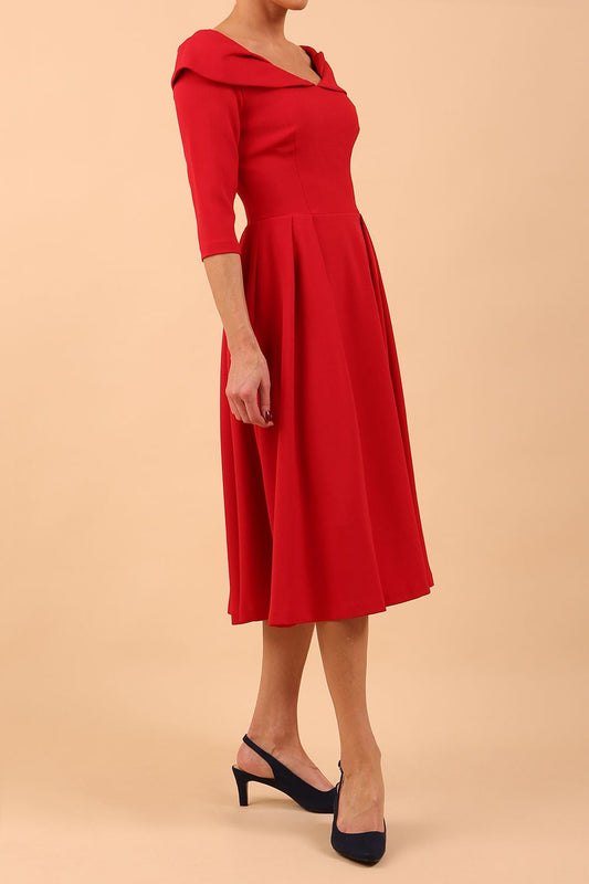 Model wearing Diva Catwalk Chesterton Sleeved dress with oversized collar detail and a-line swing pleated skirt in colour scarlet red front side