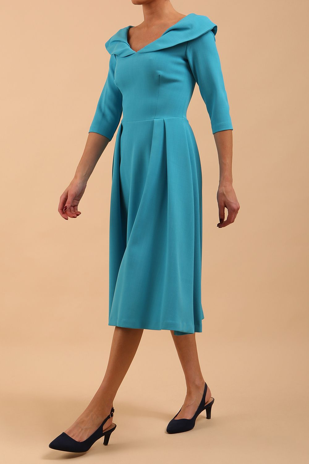 Model wearing Diva Catwalk Chesterton Sleeved dress with oversized collar detail and a-line swing pleated skirt in colour azure blue front side