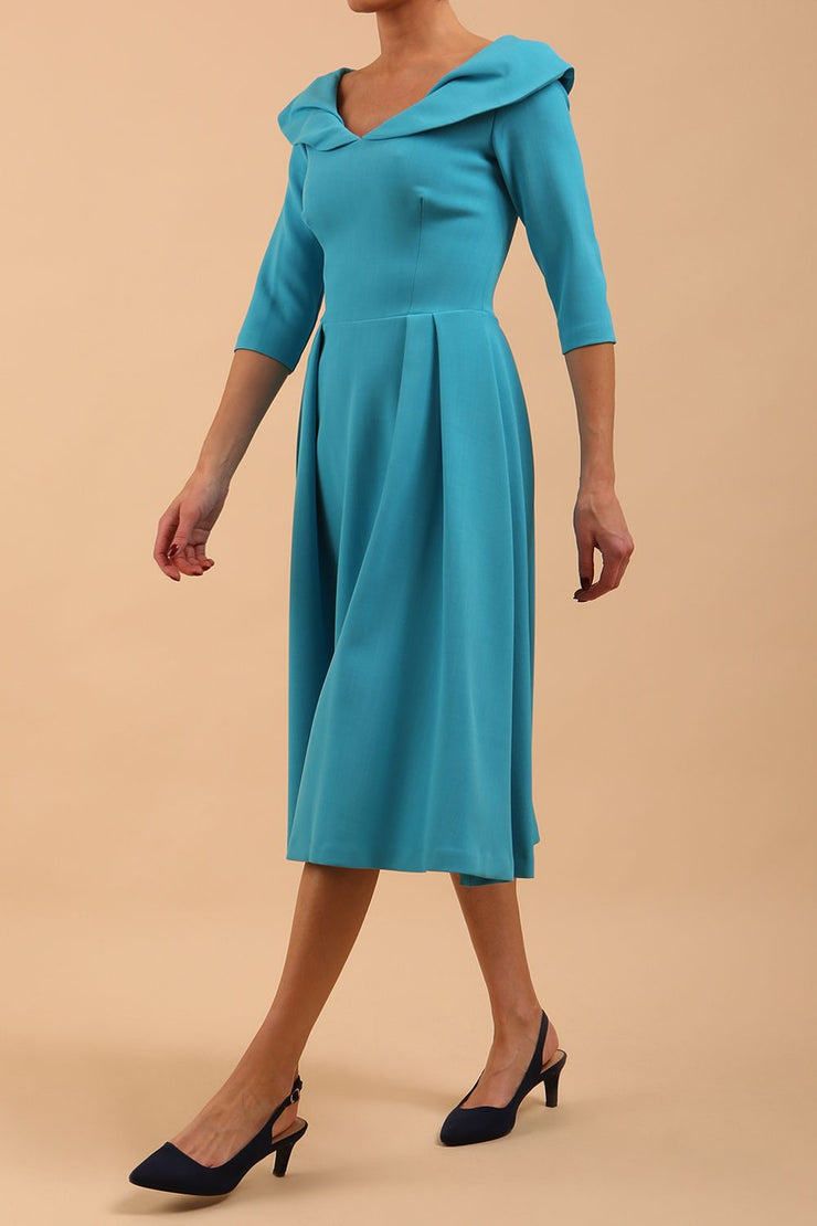 Model wearing Diva Catwalk Chesterton Sleeved dress with oversized collar detail and a-line swing pleated skirt in colour azure blue front side