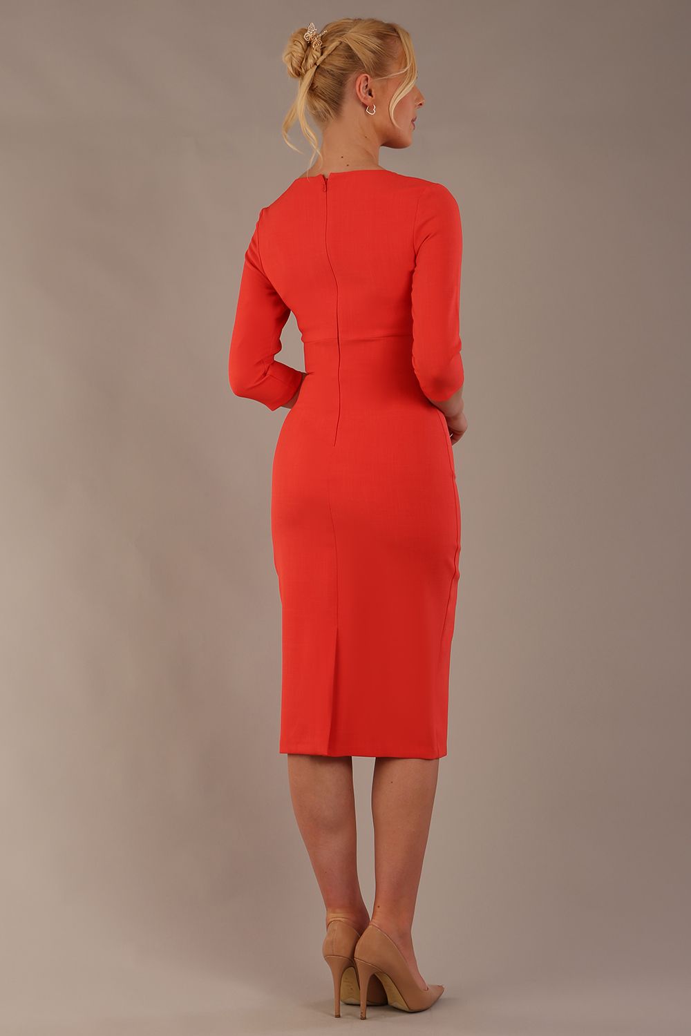 model wearing diva catwalk ubrique pencil dress with a keyhole detail and sleeves in Grenadine Orange  (Grenadine Orange)
