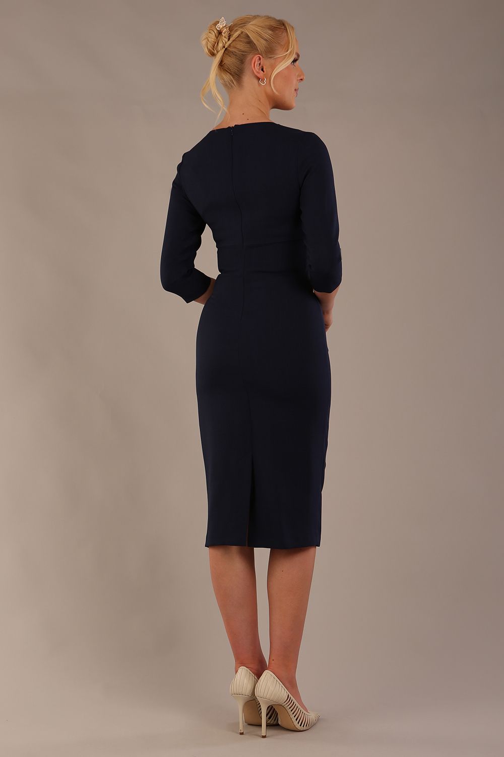 model is wearing the Diva Catwalk Ubrique pencil dress with Long sleeves and keyhole detail in Navy Blue fabric colour back (Navy)