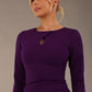 model is wearing the Diva Catwalk Ubrique pencil dress with Long sleeves and keyhole detail in Deep Purple fabric colour close-up (Deep Purple)