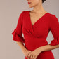 brunette model is wearing diva catwalk hollie pencil dress with frilled flute sleeve and low v-neck cut in scarlet red front close up