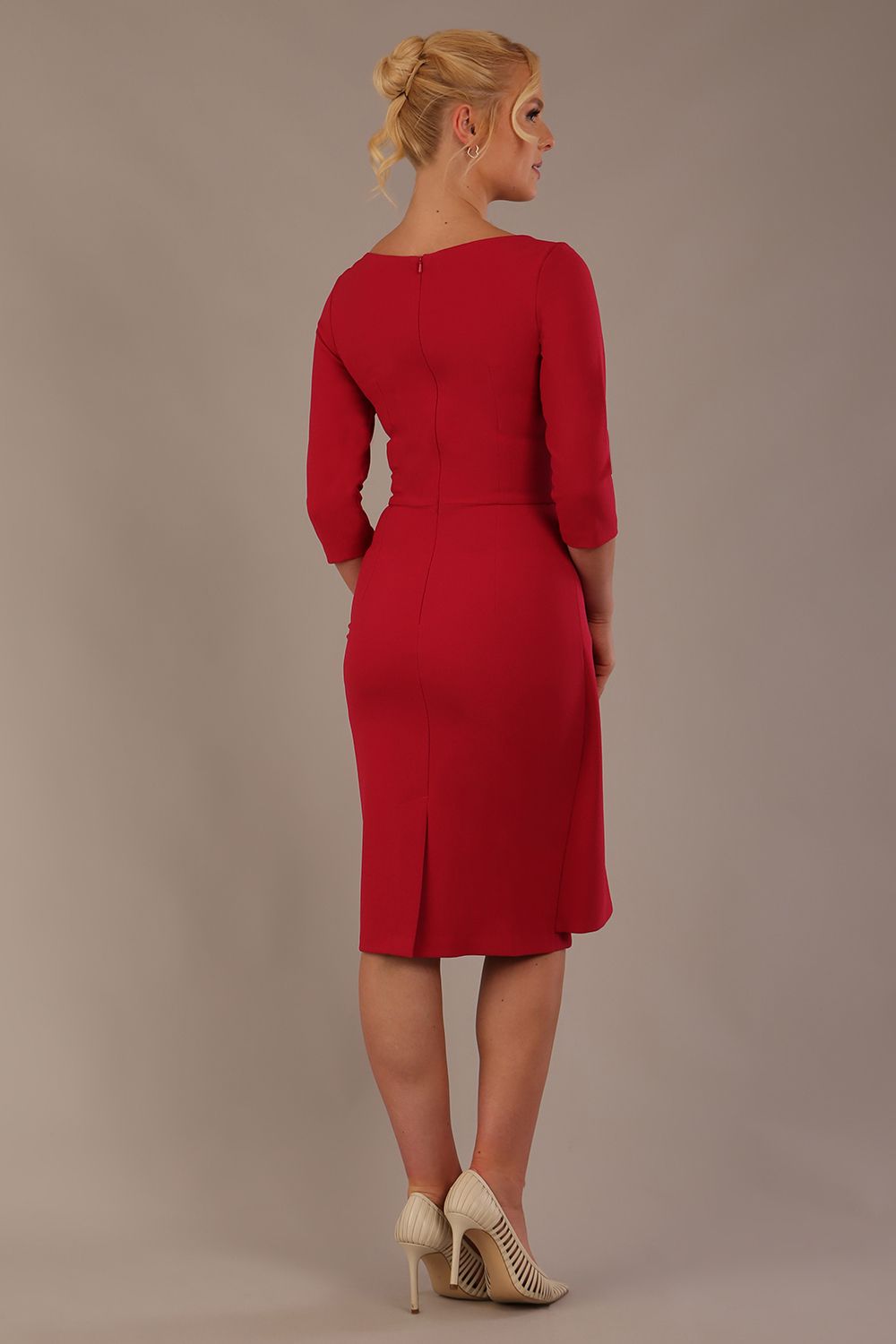 model is wearing diva catwalk jacky dress with rounded neckline 3/4 sleeve and bow detail on the waist in Dazzle pink back view