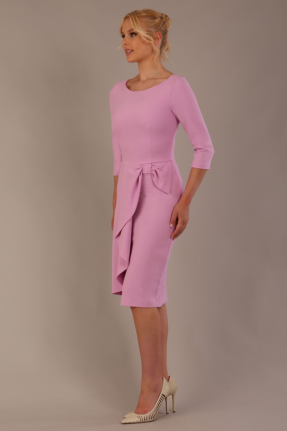 model is wearing diva catwalk jacky dress with rounded neckline 3/4 sleeve and bow detail on the waist in dawn pink front view