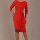 model is wearing diva catwalk jacky dress with rounded neckline 3/4 sleeve and bow detail on the waist in fiesta orange front view