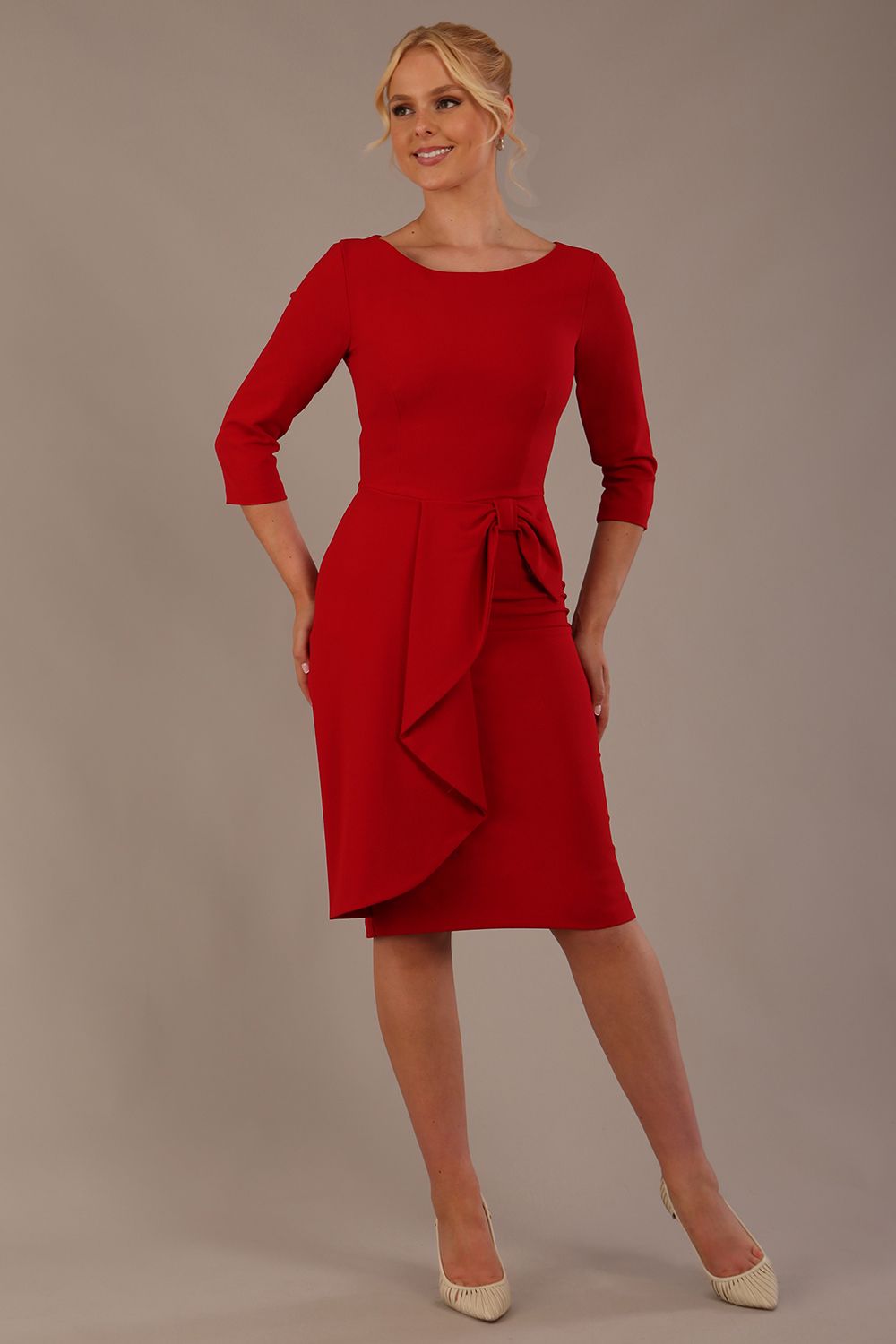 model is wearing diva catwalk jacky dress with rounded neckline 3/4 sleeve and bow detail on the waist in scarlet red front view