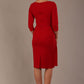 model is wearing diva catwalk jacky dress with rounded neckline 3/4 sleeve and bow detail on the waist in scarlet red back view