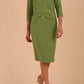 Model wearing diva catwalk Seed Andante Pencil Skirt Dress with 3/4 sleeve and bow detail at waistline in Citrus Green front 