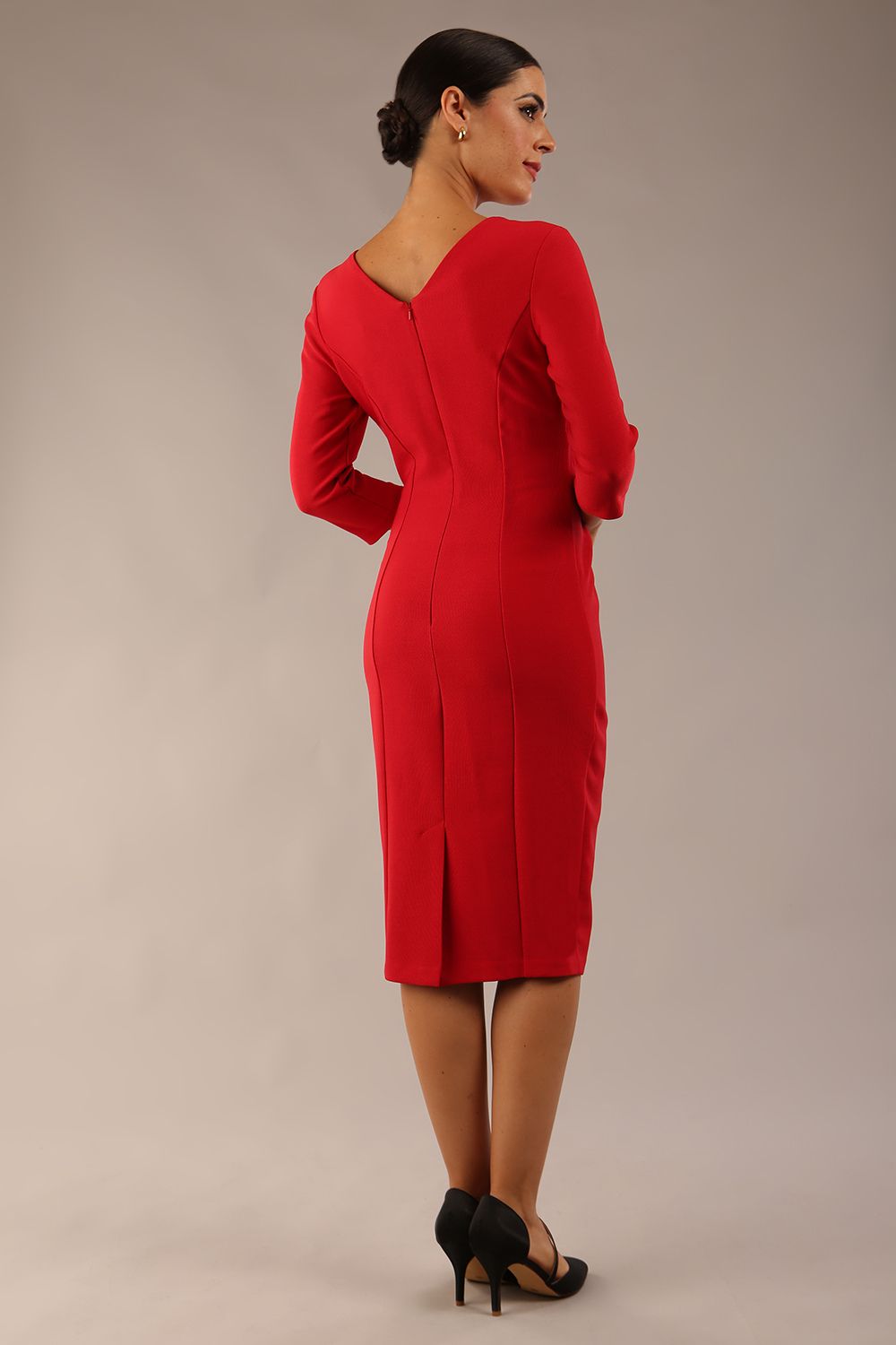 Model wearing diva catwalk Seed Andante Pencil Skirt Dress with 3/4 sleeve and bow detail at waistline in Salsa Red back