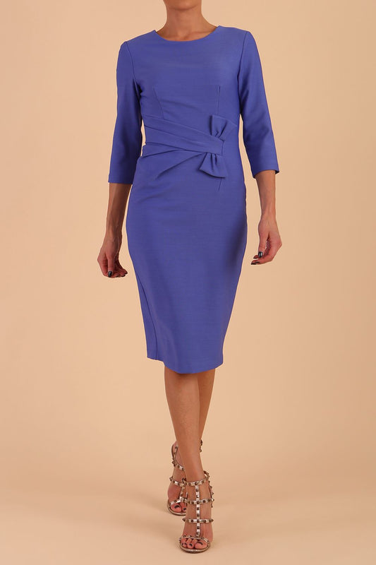 Model wearing diva catwalk Seed Andante Pencil Skirt Dress with 3/4 sleeve and bow detail at waistline in Thistle Blue front 