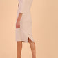 Model wearing diva catwalk Seed Andante Pencil Skirt Dress with 3/4 sleeve and bow detail at waistline in Sandy Cream back