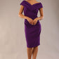 Model is wearing an off shoulder pencil dress by Diva Catwalk in deep purple