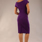 Model is wearing an off shoulder pencil dress by Diva Catwalk in deep purple