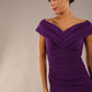 Model is wearing an off shoulder pencil dress by Diva Catwalk in deep purple