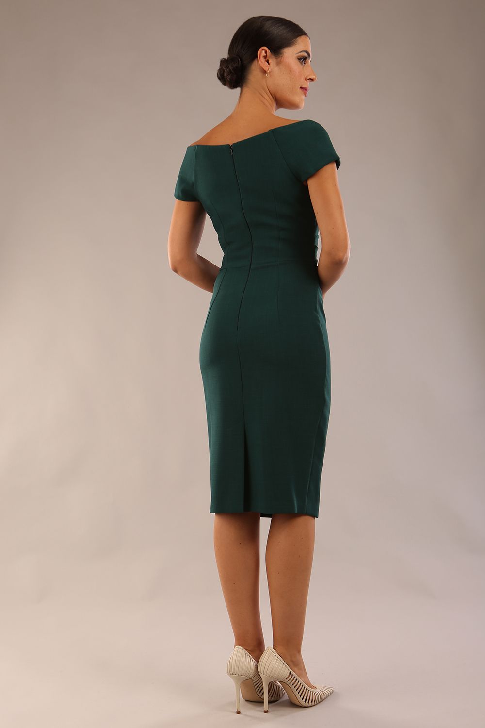 Model is wearing an off shoulder pencil dress by Diva Catwalk in forest green