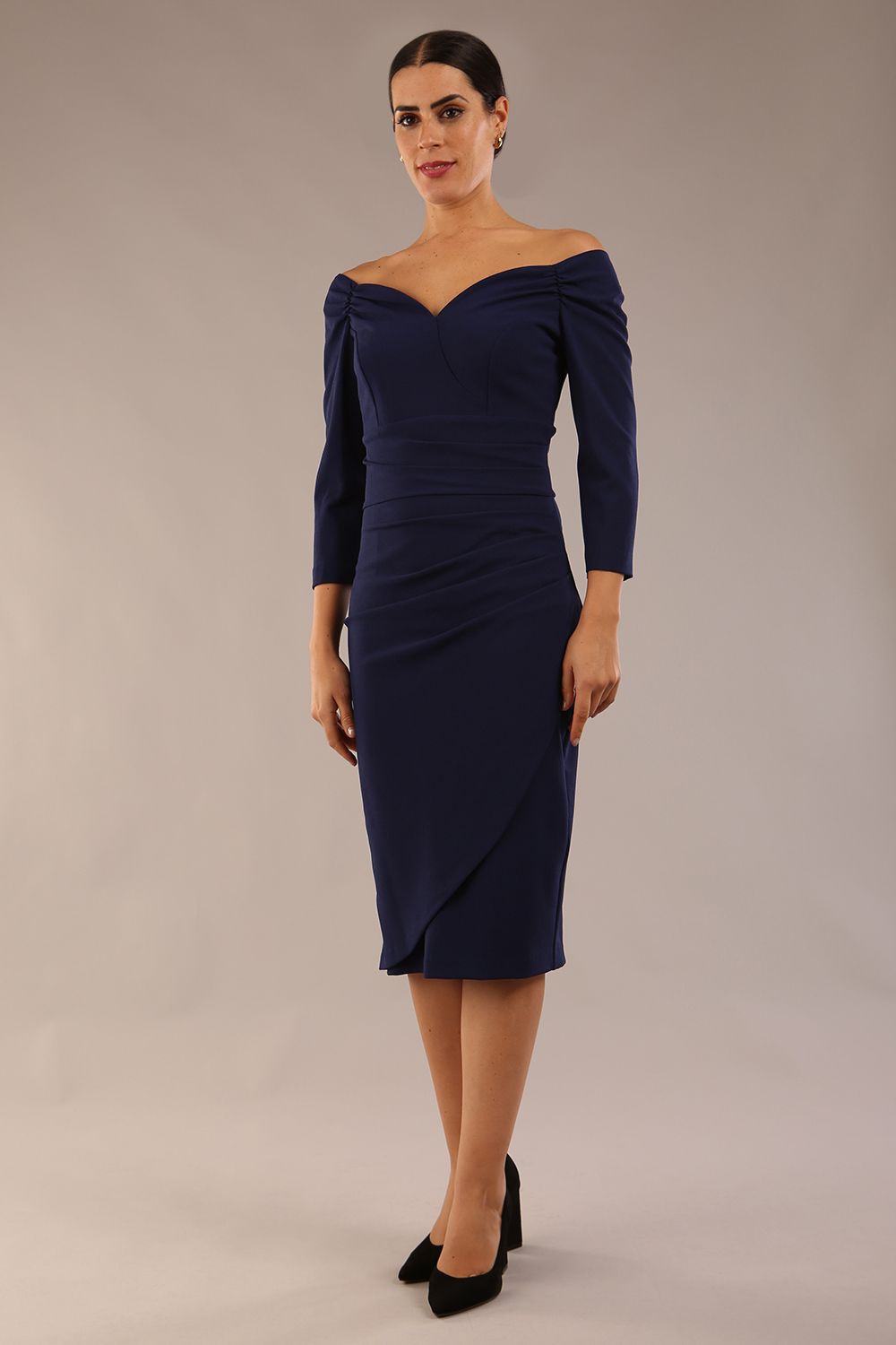 brunette model wearing diva catwalk evening pencil dress off shoulder with sleeves and pleated pencil skirt in colour navy blue front