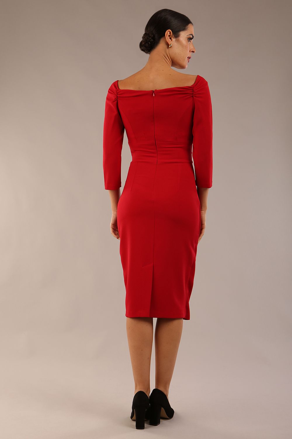 brunette model wearing diva catwalk evening pencil dress off shoulder with sleeves and pleated pencil skirt in colour scarlet red back