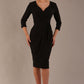 model wearing diva catwalk elan elegant black dress with 3 4 sleeves with a tie detail and asymmetrical closing front (Black)