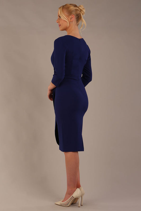model wearing diva catwalk elan elegant black dress with 3 4 sleeves with a tie detail and asymmetrical closing back (Oxford Blue)