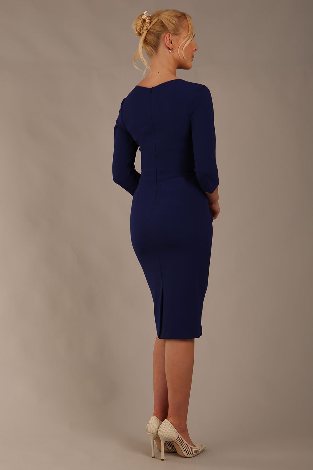 model wearing diva pencil dress tulip design with overlapping pencil skirt with 3 4 sleeves in colour oxford blue back (Oxford Blue)