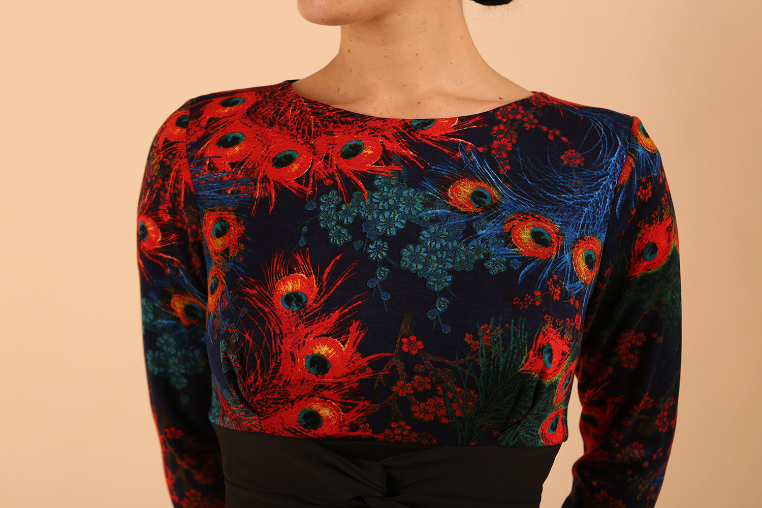 Model wearing the Diva Chiltern Print dress with round neckline in feathers print front image close up