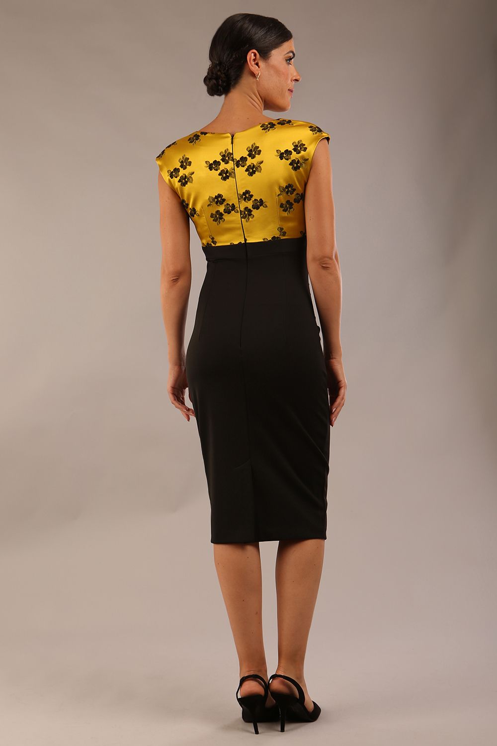 brunette model wearing diva catwalk  dresses from england nadia colour block in black and gold colours sleeveless dress front