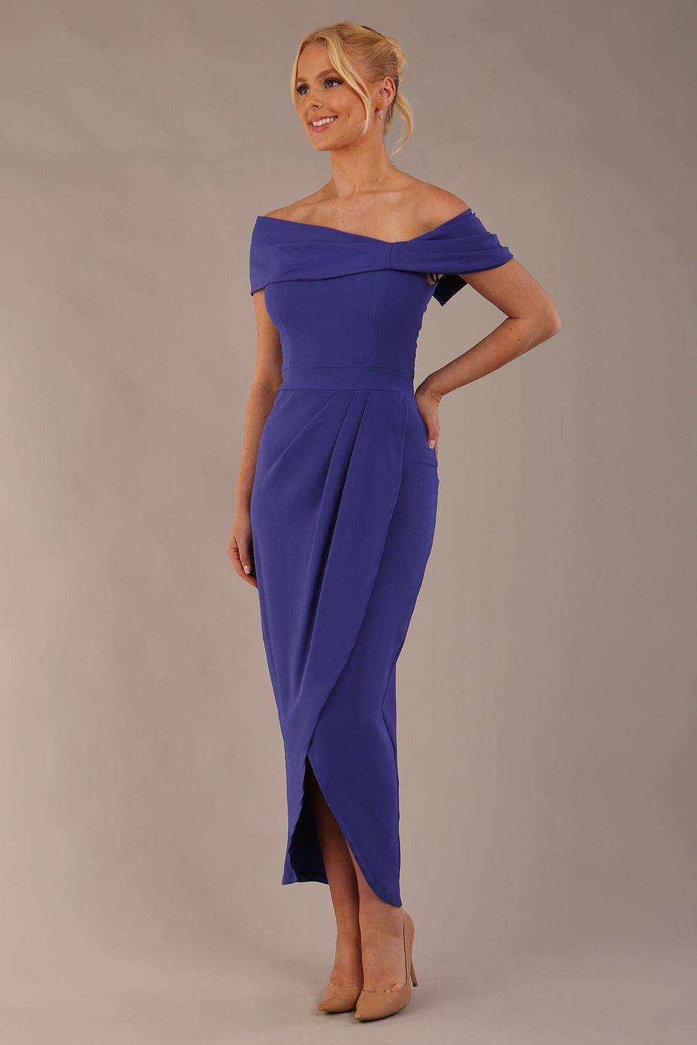 model wearing diva catwalk vegas calf length spectrum indigo midaxi dress with wide bardot neckline and open shoulders with a large opening at the front of the skirt with pleating coming down long skirt front (Spectrum Indigo)