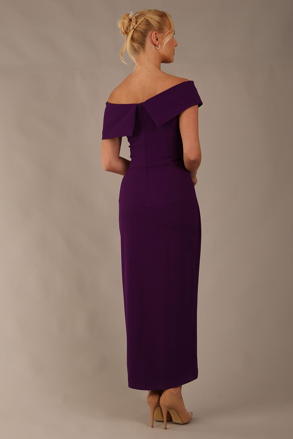 model wearing diva catwalk vegas calf length passion purple midaxi dress with wide bardot neckline and open shoulders with a large opening at the front of the skirt with pleating coming down long skirt front (Passion Purple)
