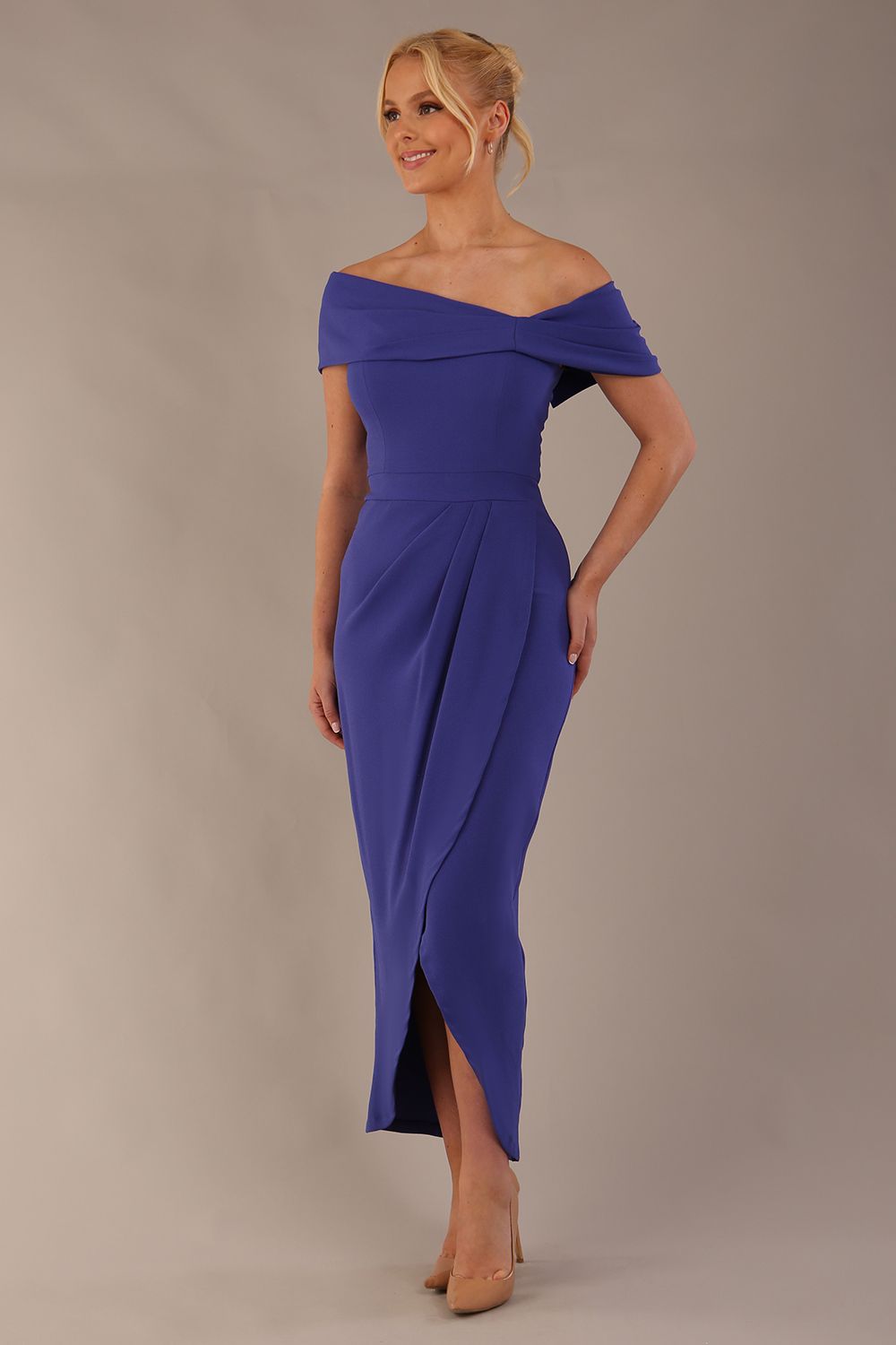 model wearing diva catwalk vegas calf length spectrum indigo midaxi dress with wide bardot neckline and open shoulders with a large opening at the front of the skirt with pleating coming down long skirt front (Spectrum Indigo)