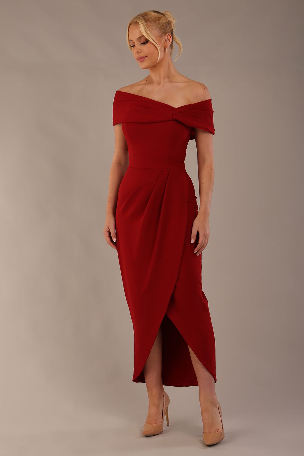 model wearing diva catwalk vegas calf length rosewood red midaxi dress with wide bardot neckline and open shoulders with a large opening at the front of the skirt with pleating coming down long skirt front (Rosewood Red)