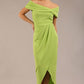 brunette model wearing diva catwalk vegas calf length lime green midaxi dress with wide bardot neckline and open shoulders with a large opening at the front of the skirt with pleating coming down long skirt front 