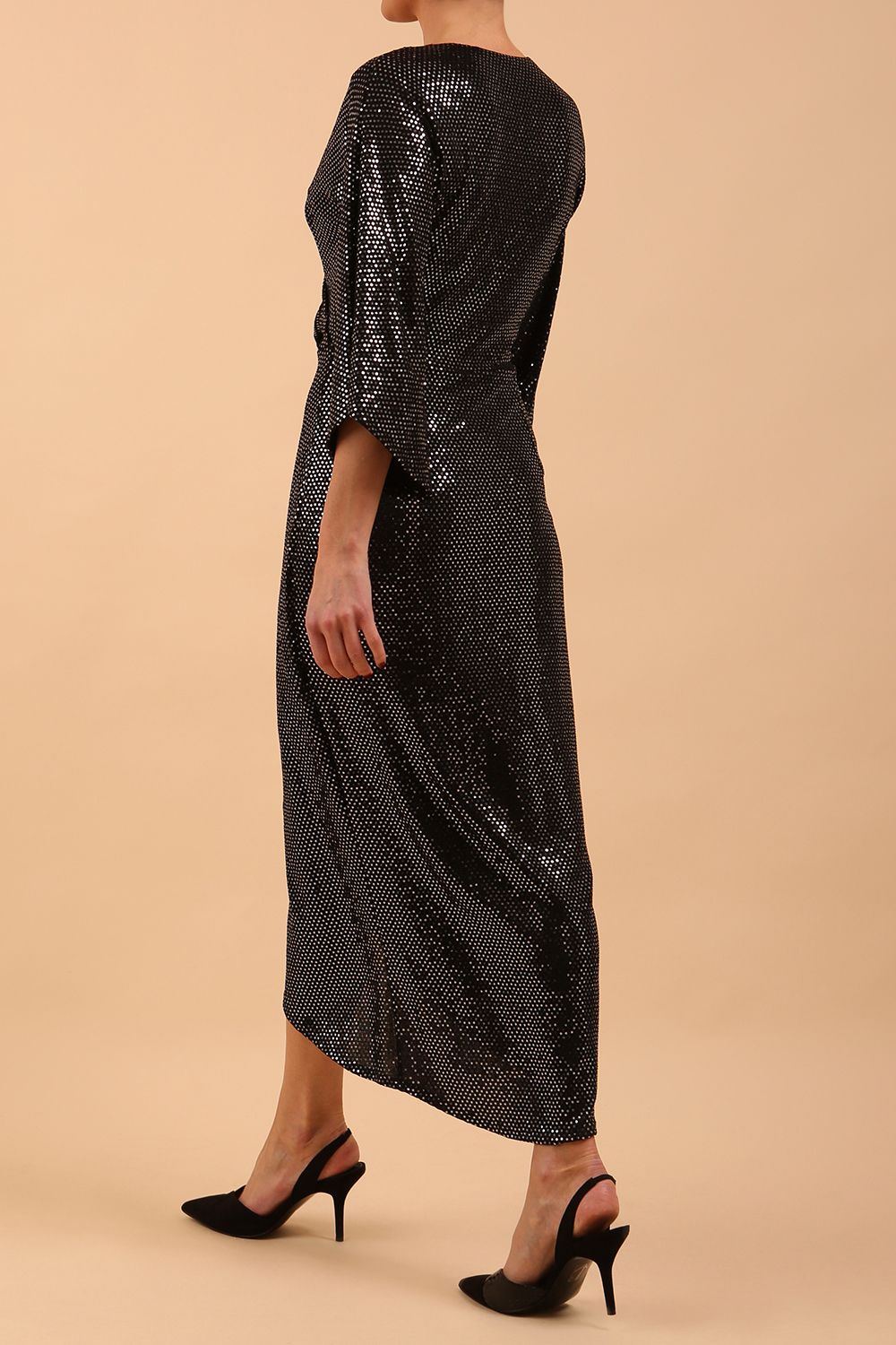 Brunette model wearing diva catwalk Glitterati Midaxi Sparkle Dress in Black in Jersey sparkle and ITY lining with wrap dress style and 3/4 length bell sleeves back