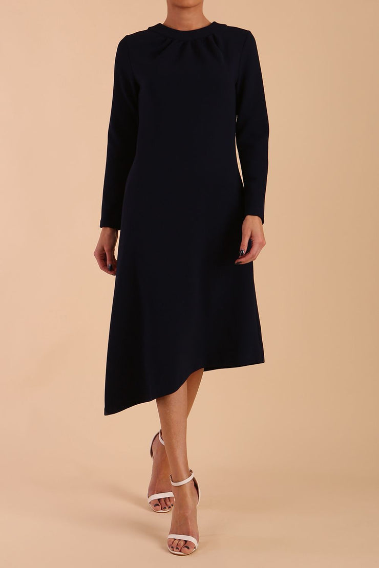model is wearing diva catwalk dartington asymmetric skirt midaxi long sleeve dress with rounded pleated neckline a-line style in navy blue front