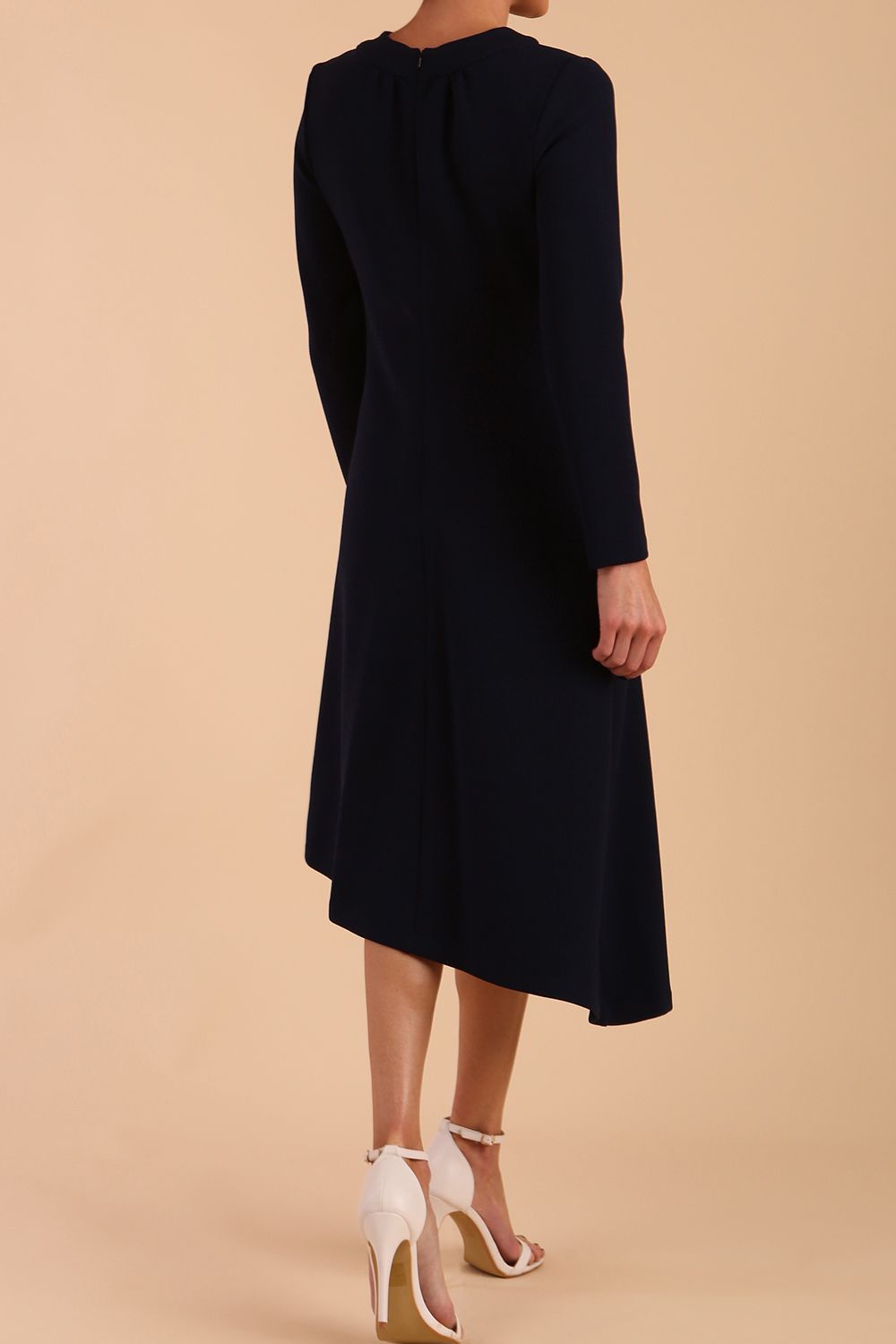 model is wearing diva catwalk dartington asymmetric skirt midaxi long sleeve dress with rounded pleated neckline a-line style in navy blue back