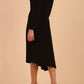 model is wearing diva catwalk dartington asymmetric skirt midaxi long sleeve dress with rounded pleated neckline a-line style in black side back