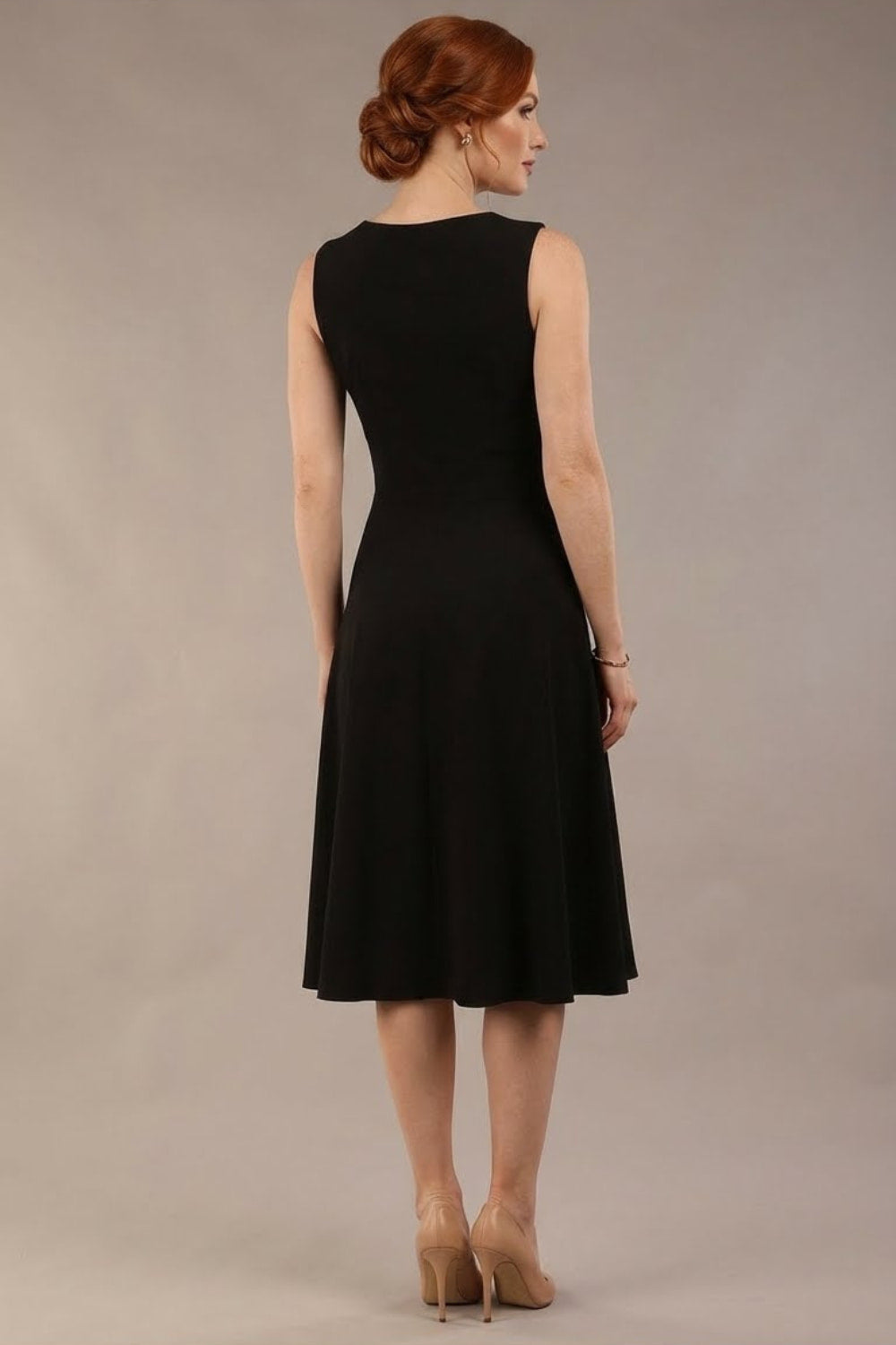 model wearing Diva Catwalk Patina A-line Swing Sleeveless dress with v-neckline with butterfly detail in Black back (Black and Black)